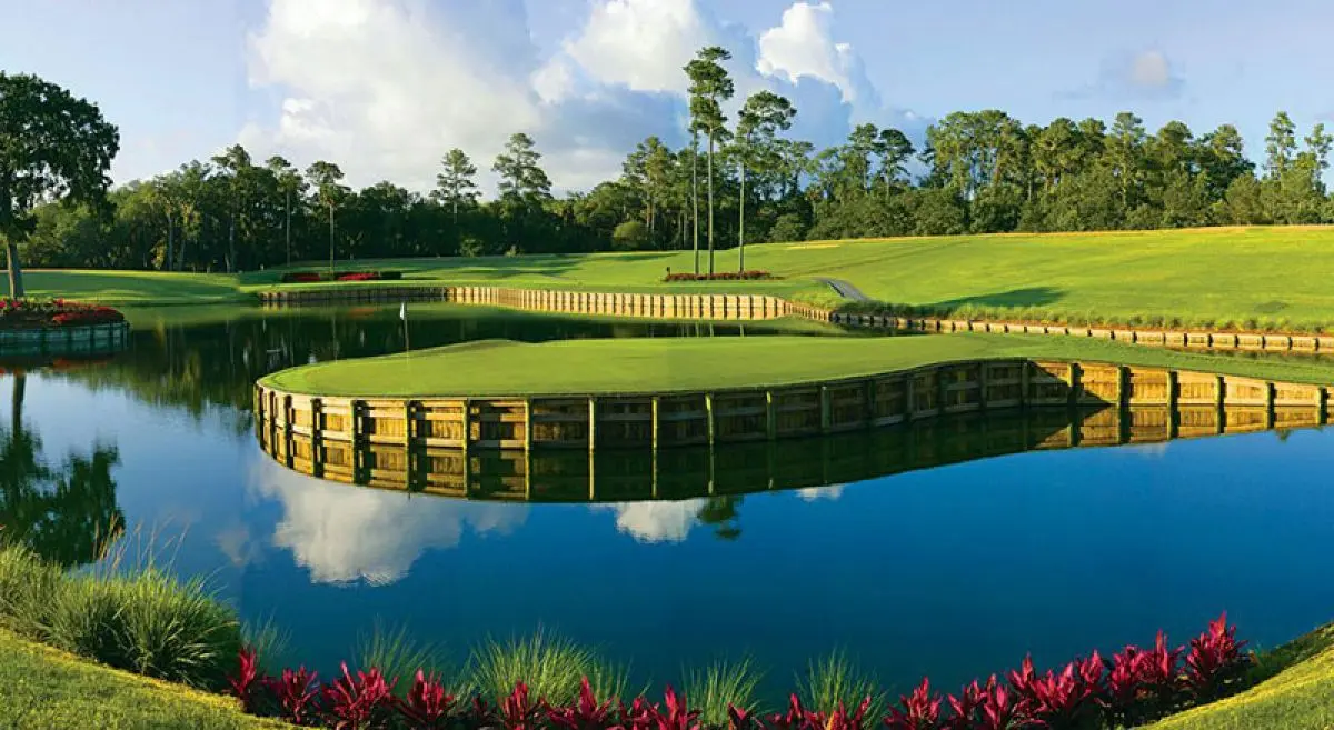 A well maintained fairway elevated from a water hazard