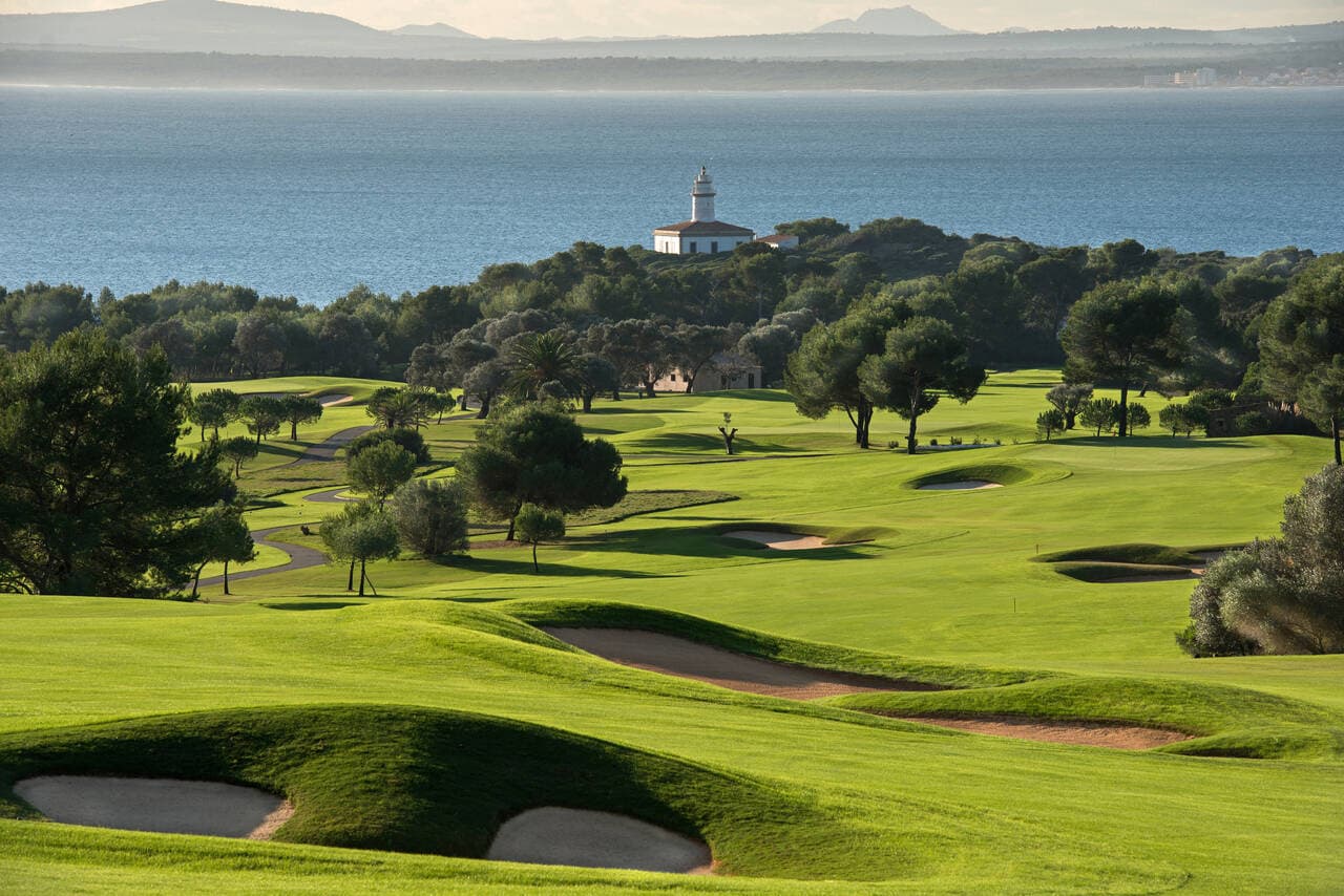 A well maintained fairway nestled with sand bunkers