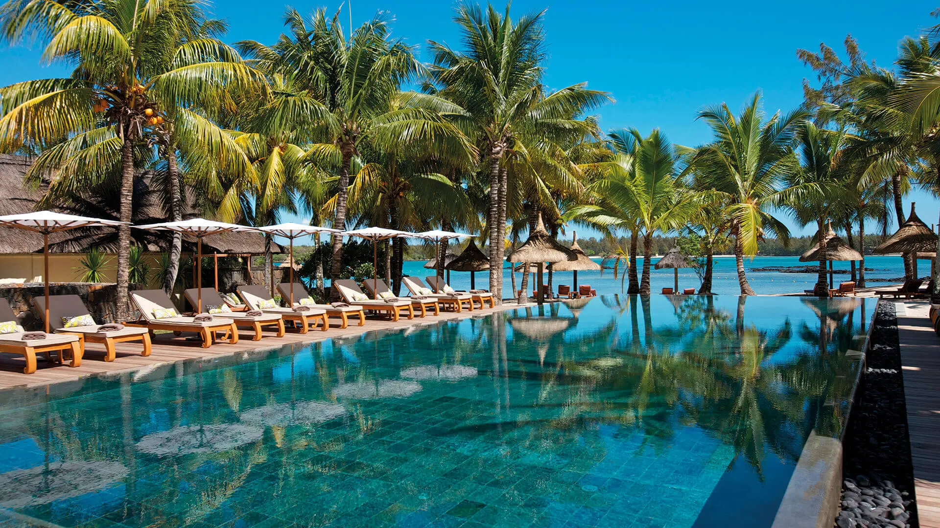 Outdoor swimming pool surrounded by sunbeds