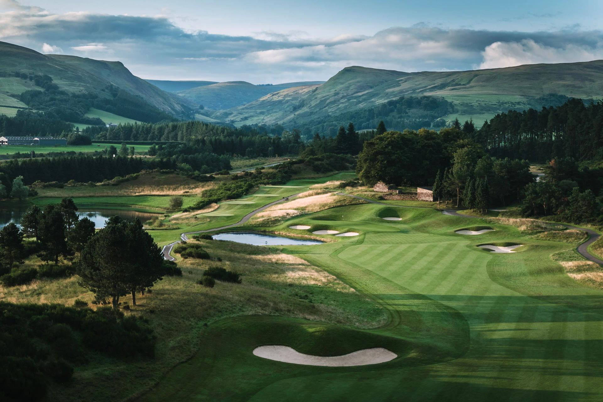 A well maintained fairway nestled with sand bunkers