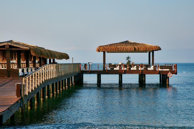 Pier on the beach with sun loungers