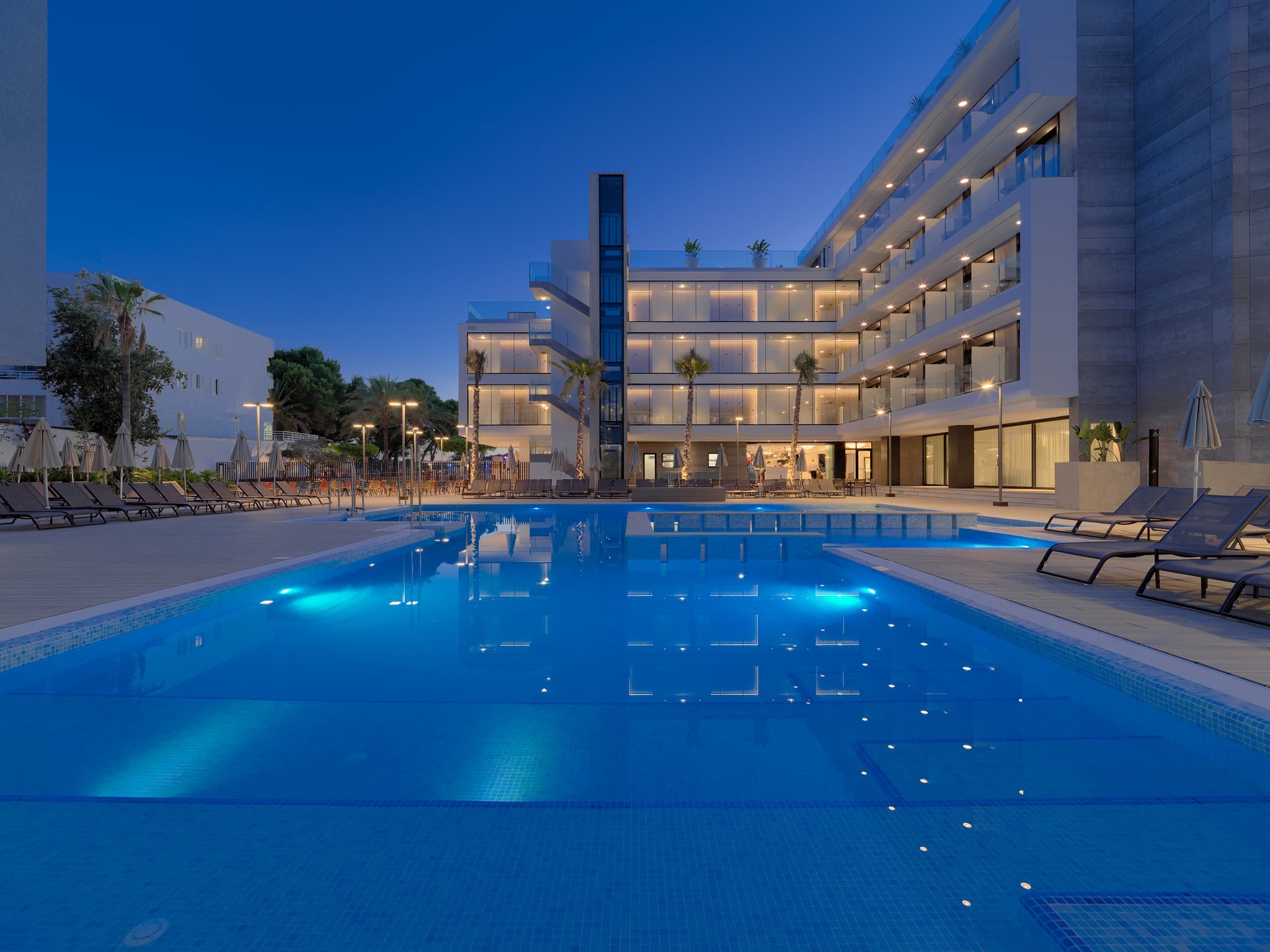Panoramic view of the H10 Casa Del Mar reflecting off the outdoor pool at evening time