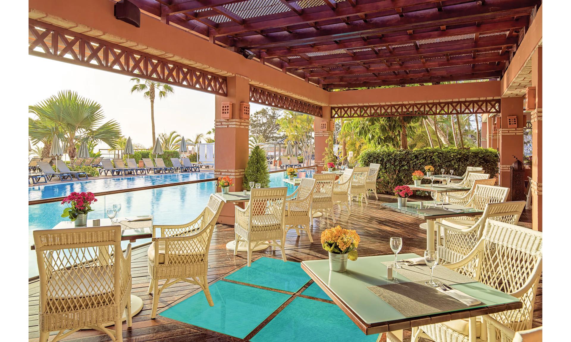 Outdoor poolside lounging area at H10 Costa Adeje Palace