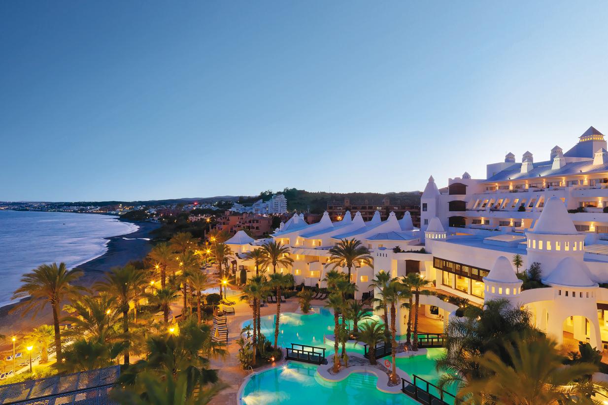 Overhead view of the outdoor swimming pool and coast at evening time