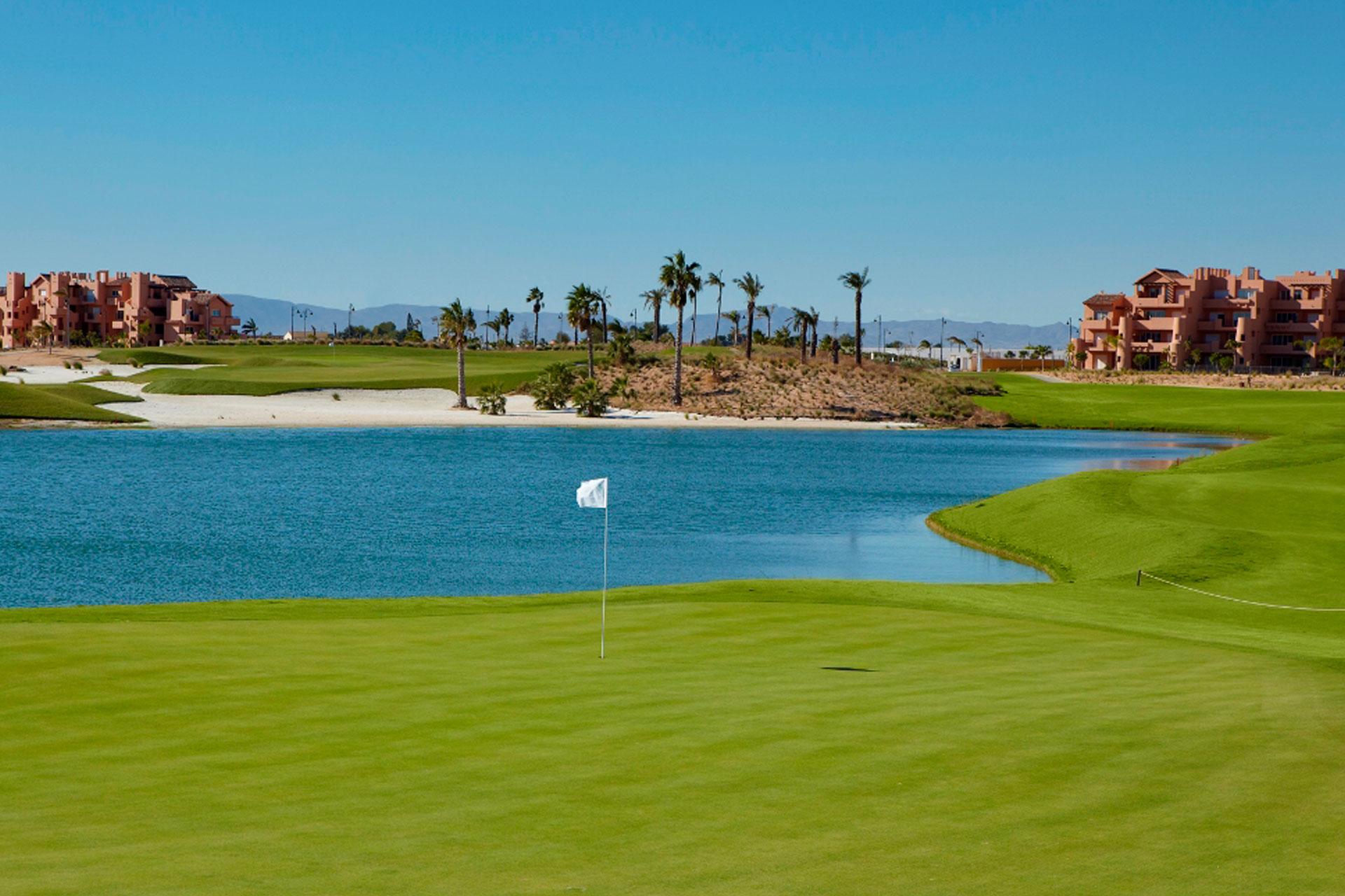 Manicured green with large water hazard behind it
