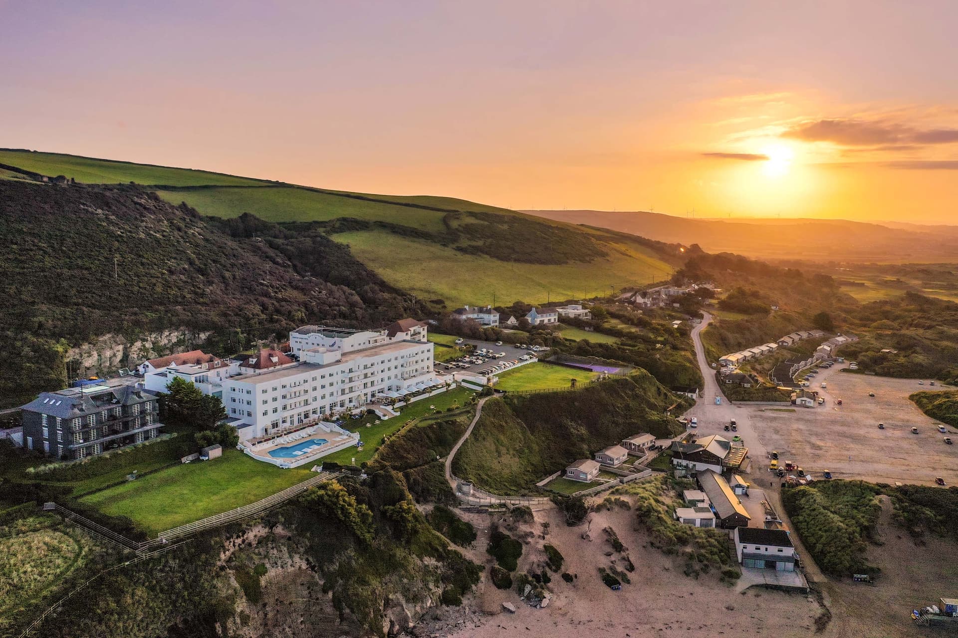 Aerial view of the sun setting over the Saunton Sands Hotel