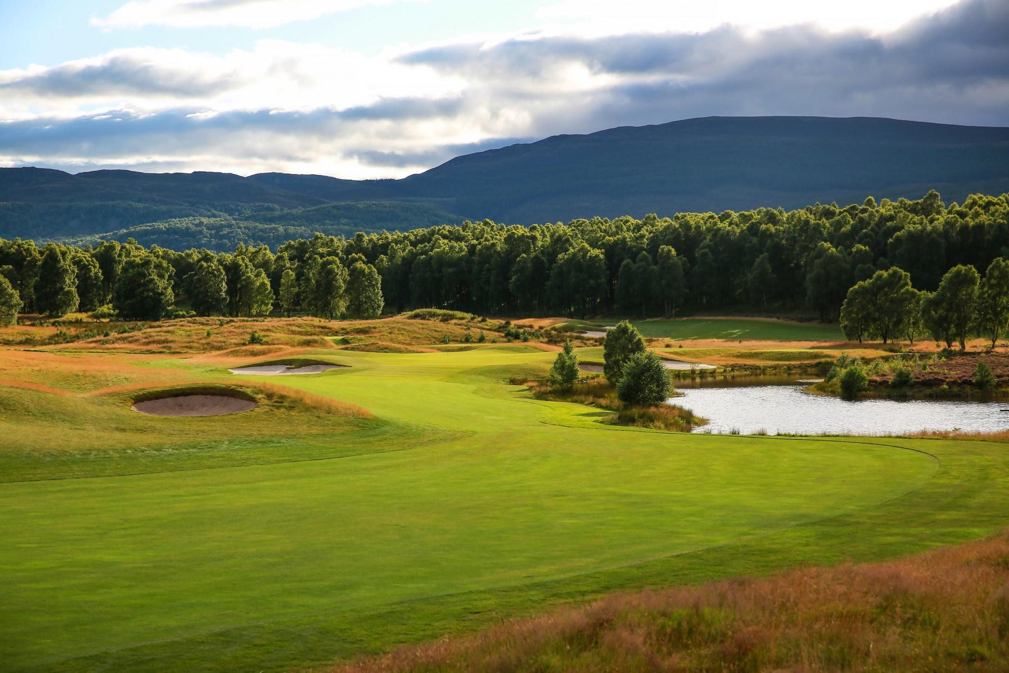 A well maintained fairway with a water hazard