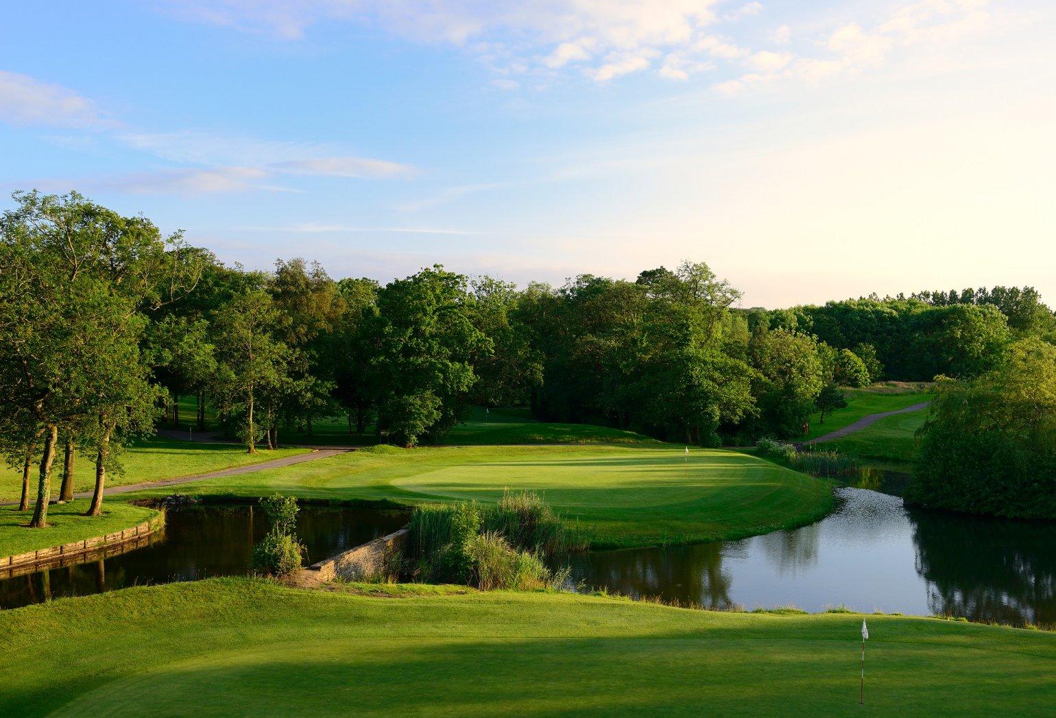 A winding fairway with a water hazard