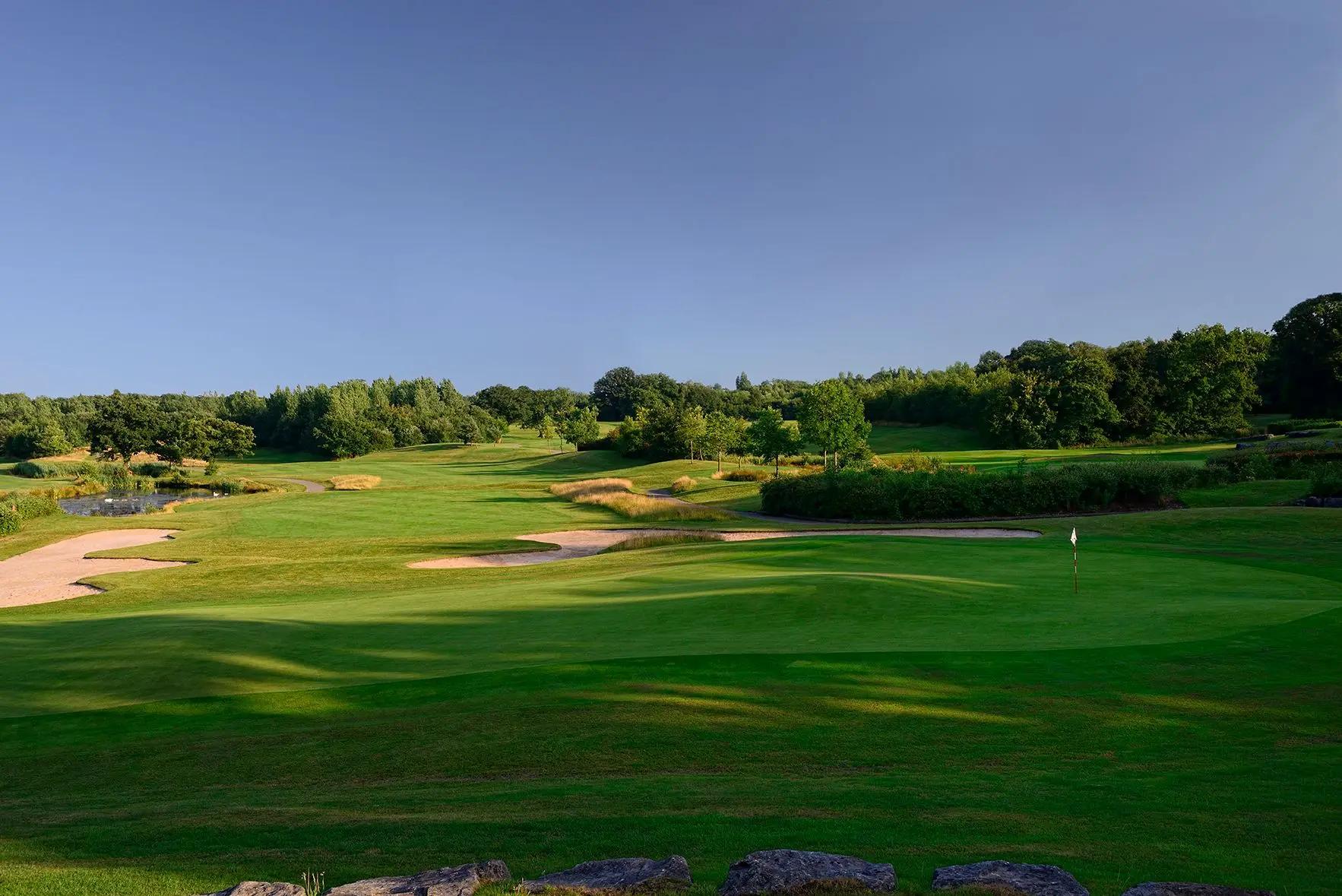 A well maintained fairway nestled with sand bunkers