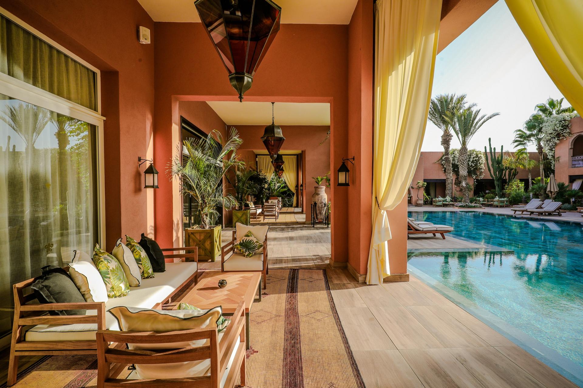 Villas patio space leading to an outdoor swimming pool