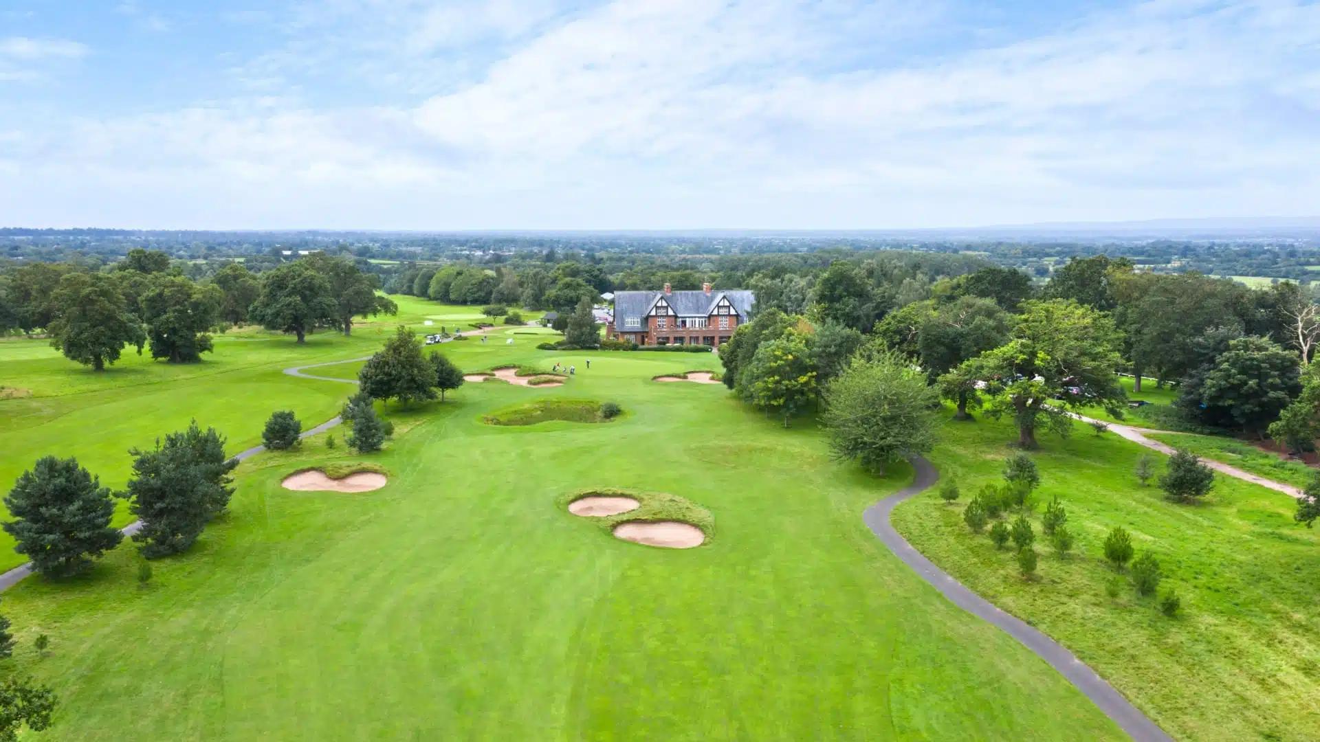 A well maintained fairway nestled with sand bunkers