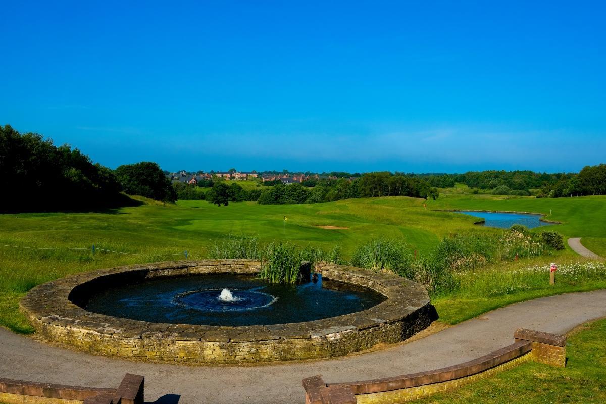 A well maintained fairway under clear blue skies