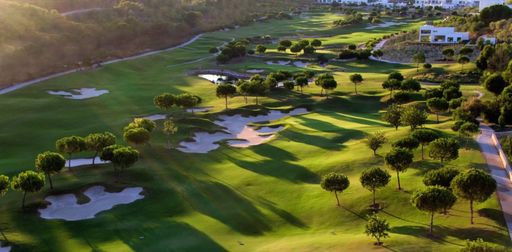 A well maintained fairway nestled with sand bunkers