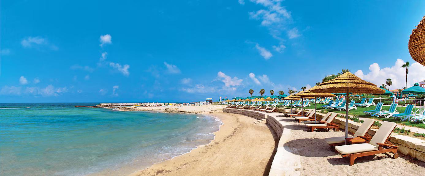 Sunbeds lined on the beach at Olympic Lagoon Resort