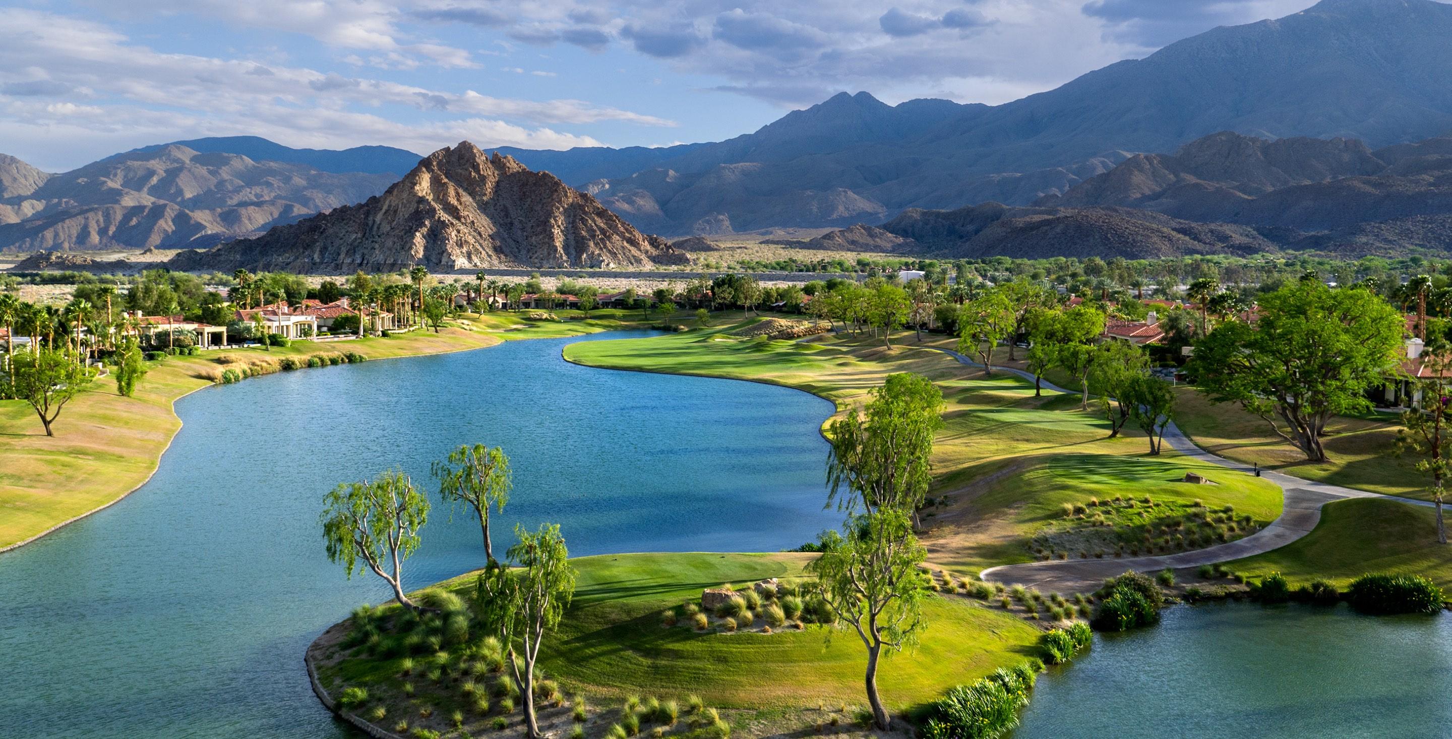 Overhead view of a well maintained fairway next to a water hazard