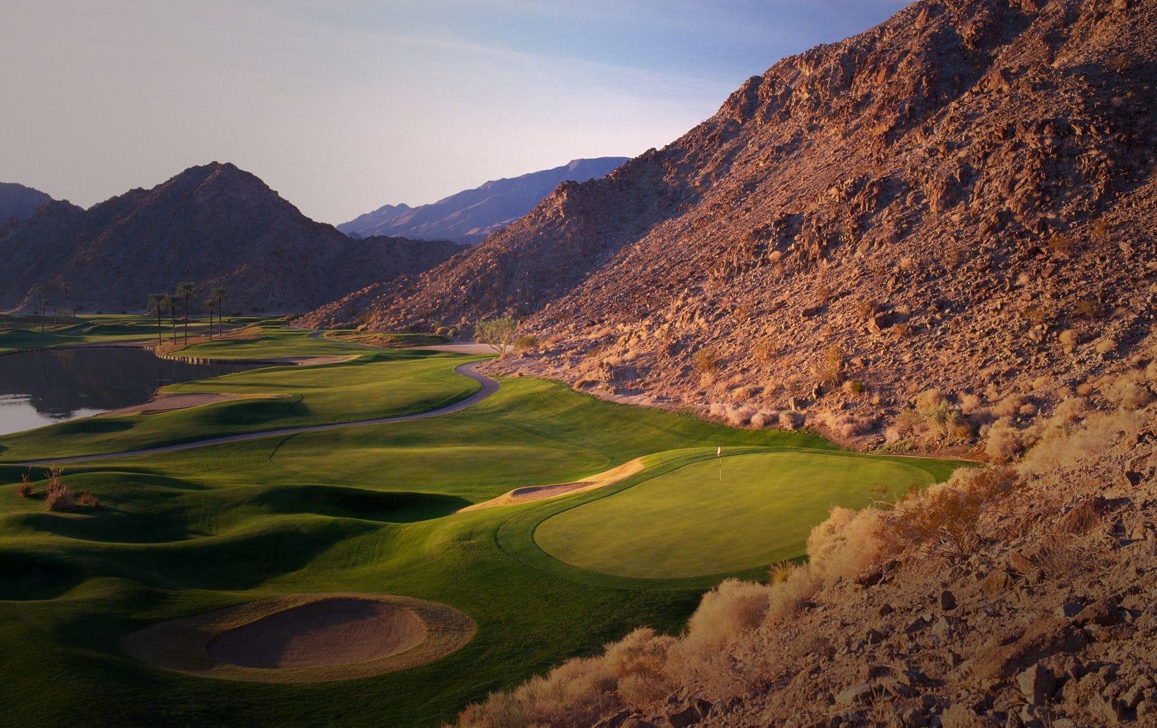 A well maintained fairway nestled with and bunkers leading to a smooth green at La Quinta Resort & Club
