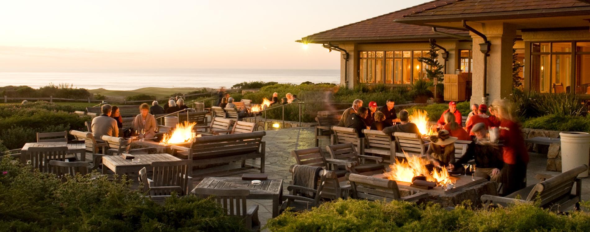 Outdoor lounging area with firepits and coastal views