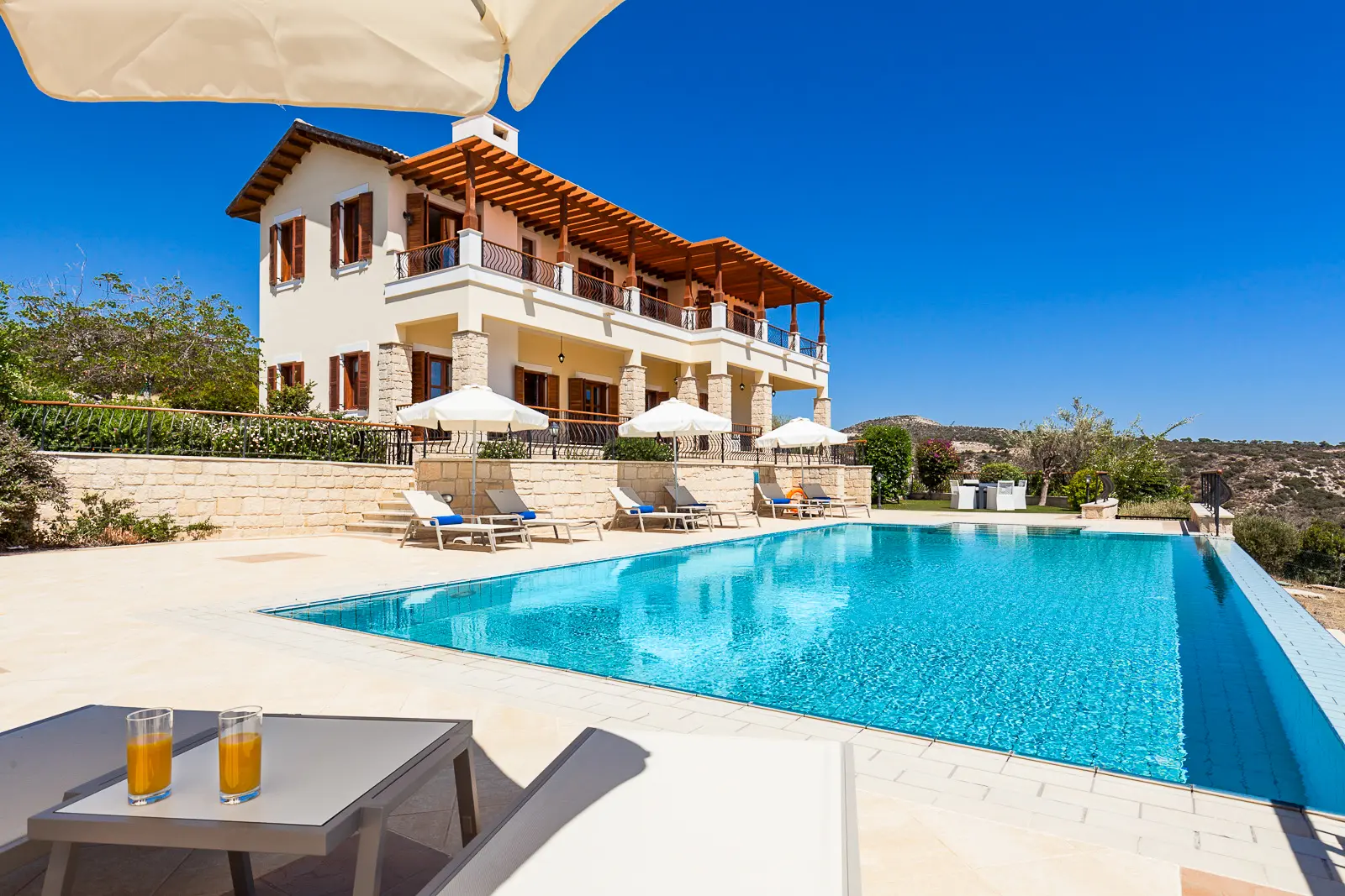 Panoramic view of a private pool and villa at Aphrodite Hills Resort