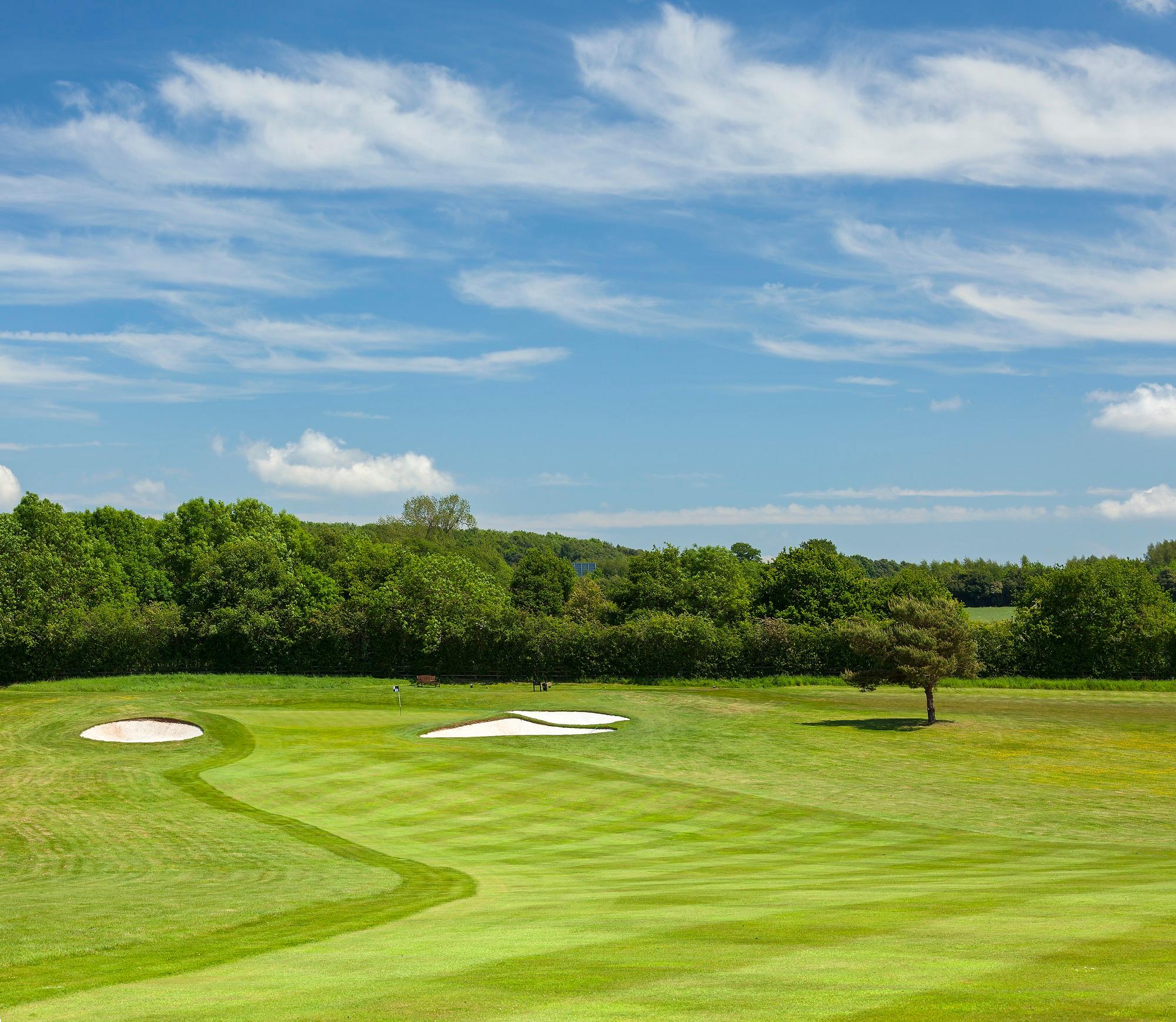 A well maintained fairway leading to a smooth green