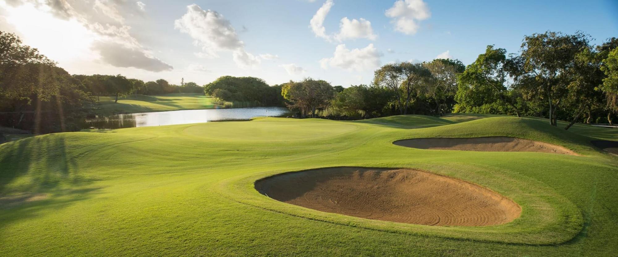 A well maintained fairway nestled with sand bunkers at Constance Belle Mare Plage