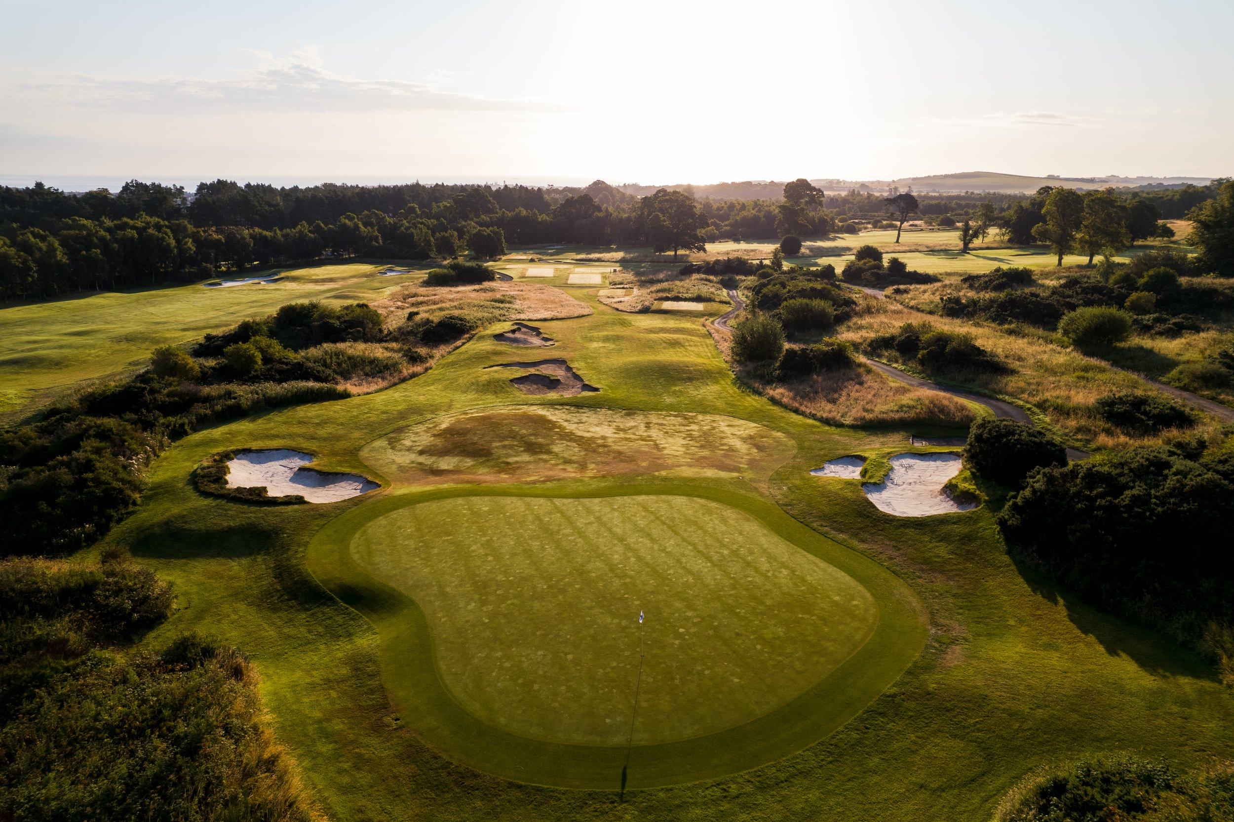 A smooth green surrounded by sand bunkers