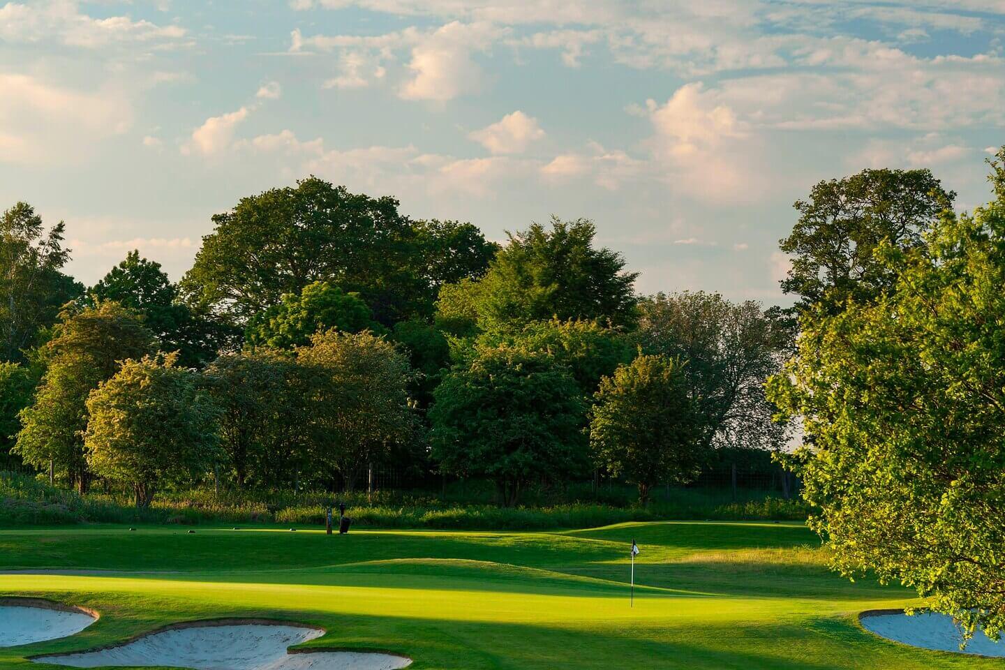 A smooth green surrounded by sand bunkers