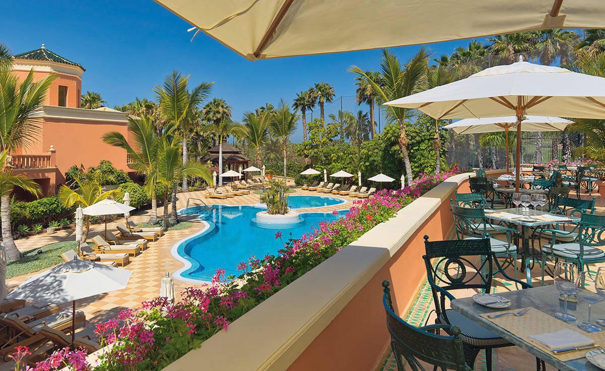 Balcony dining area overlooking the pool