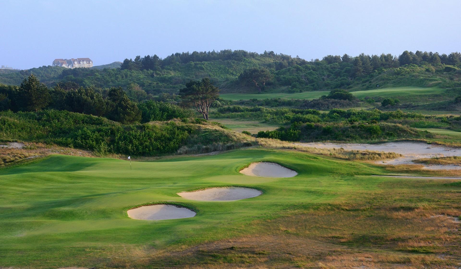 A smooth green lined with three sand bunkers