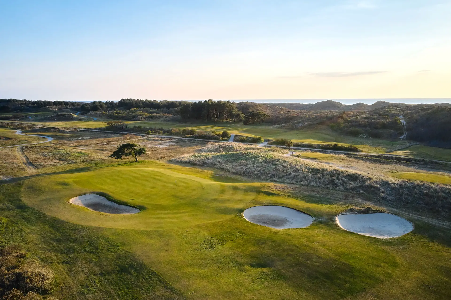 Overhead view of a well maintained fairway nestled with sand bunkers