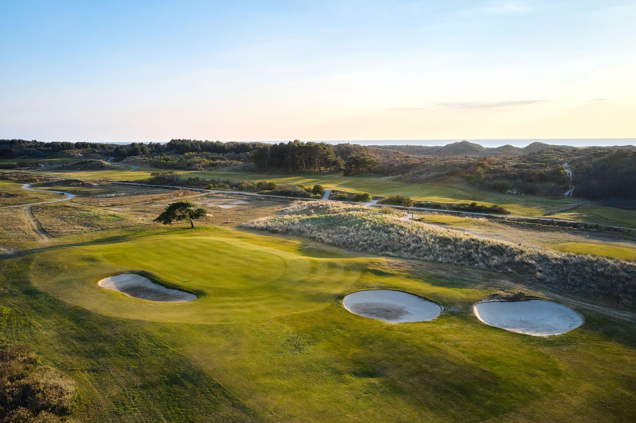 Overhead view of a well maintained fairway nestled with sand bunkers