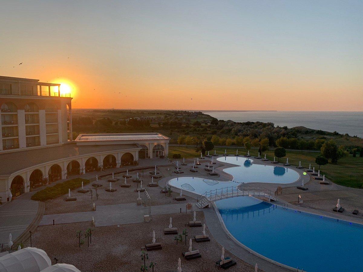 Sun setting over the outdoor swimming pool at the Lighthouse Golf & Spa Resort