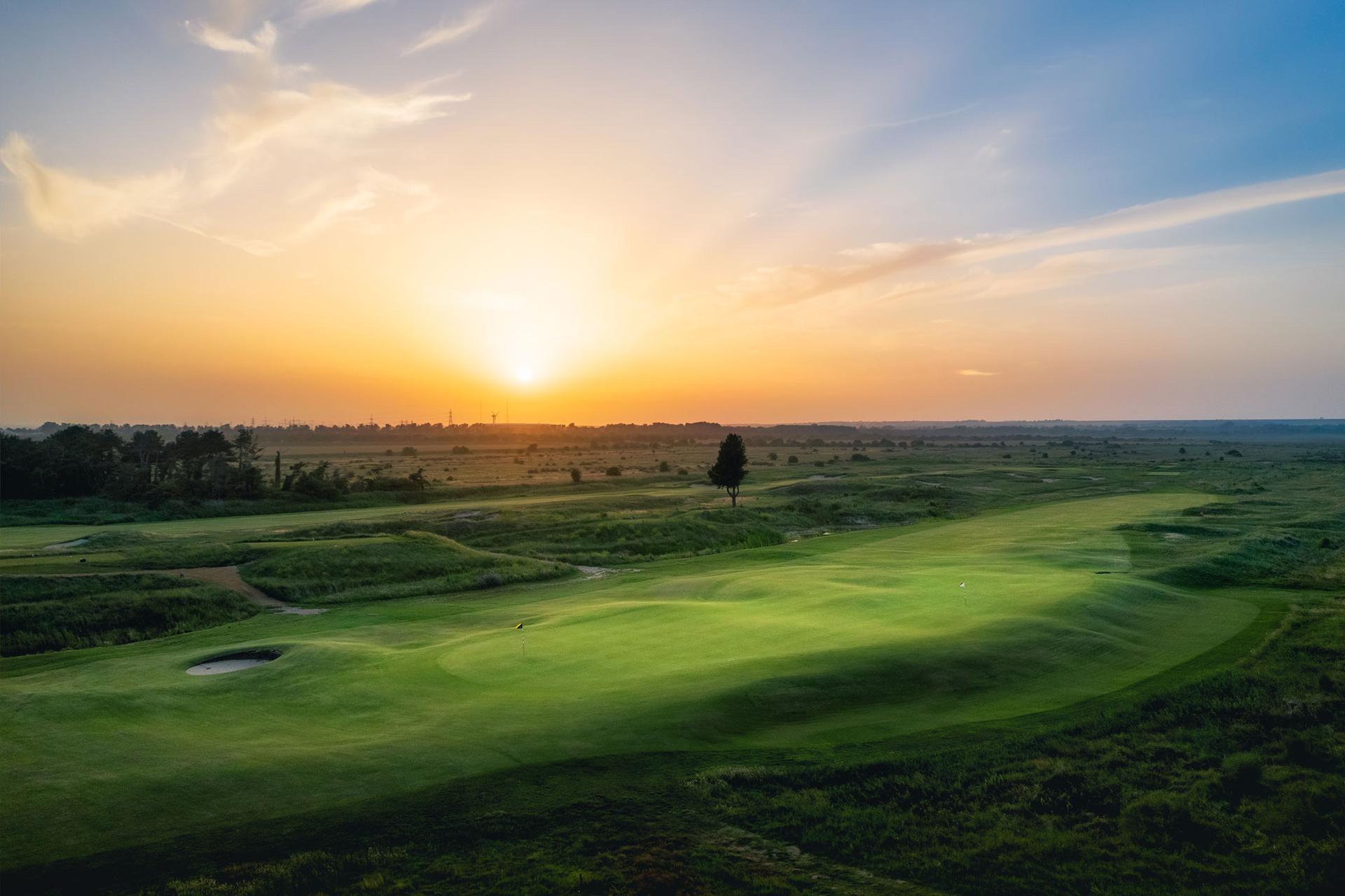 Sun setting over a well maintained fairway