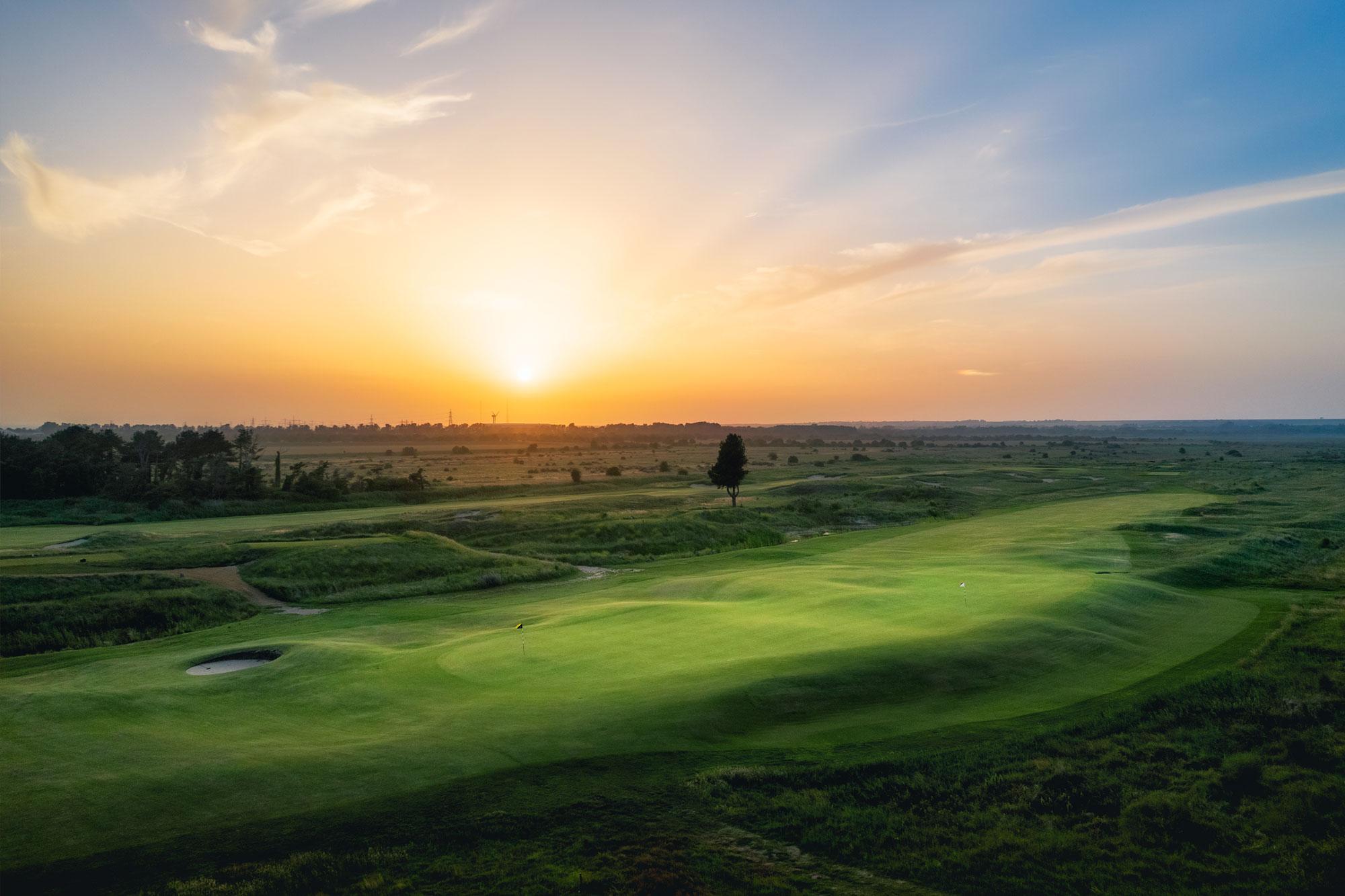 Sun setting over a well maintained fairway