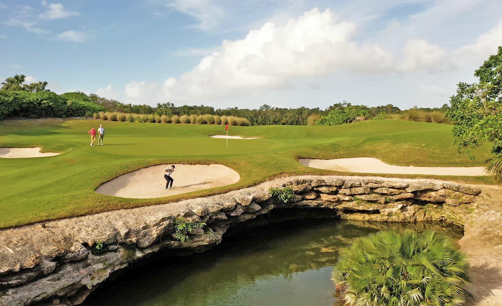 Golfer swinging out of a sand bunker at Moon Palace Golf Club
