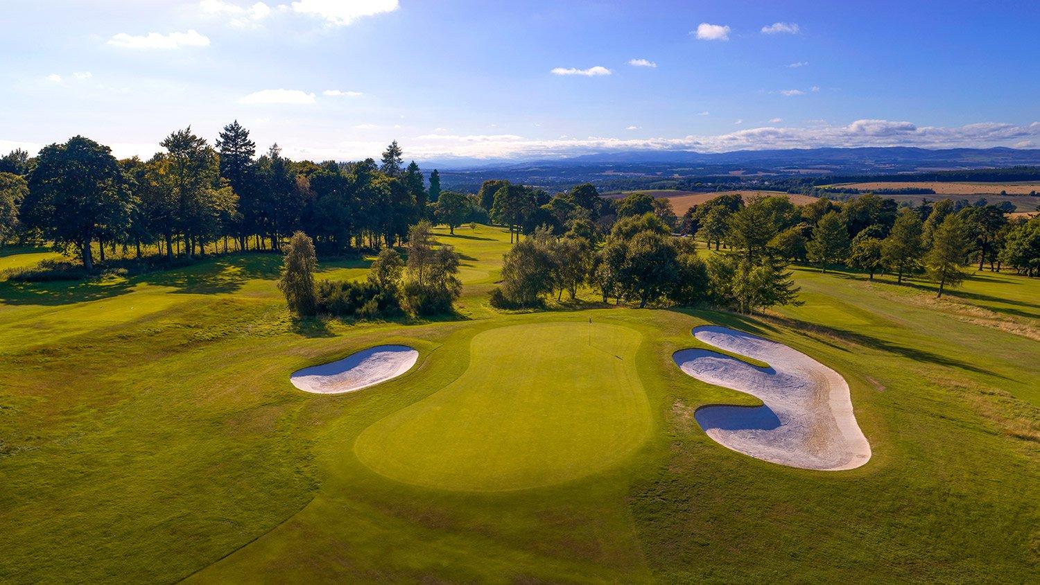 A smooth green surrounded by sand bunkers
