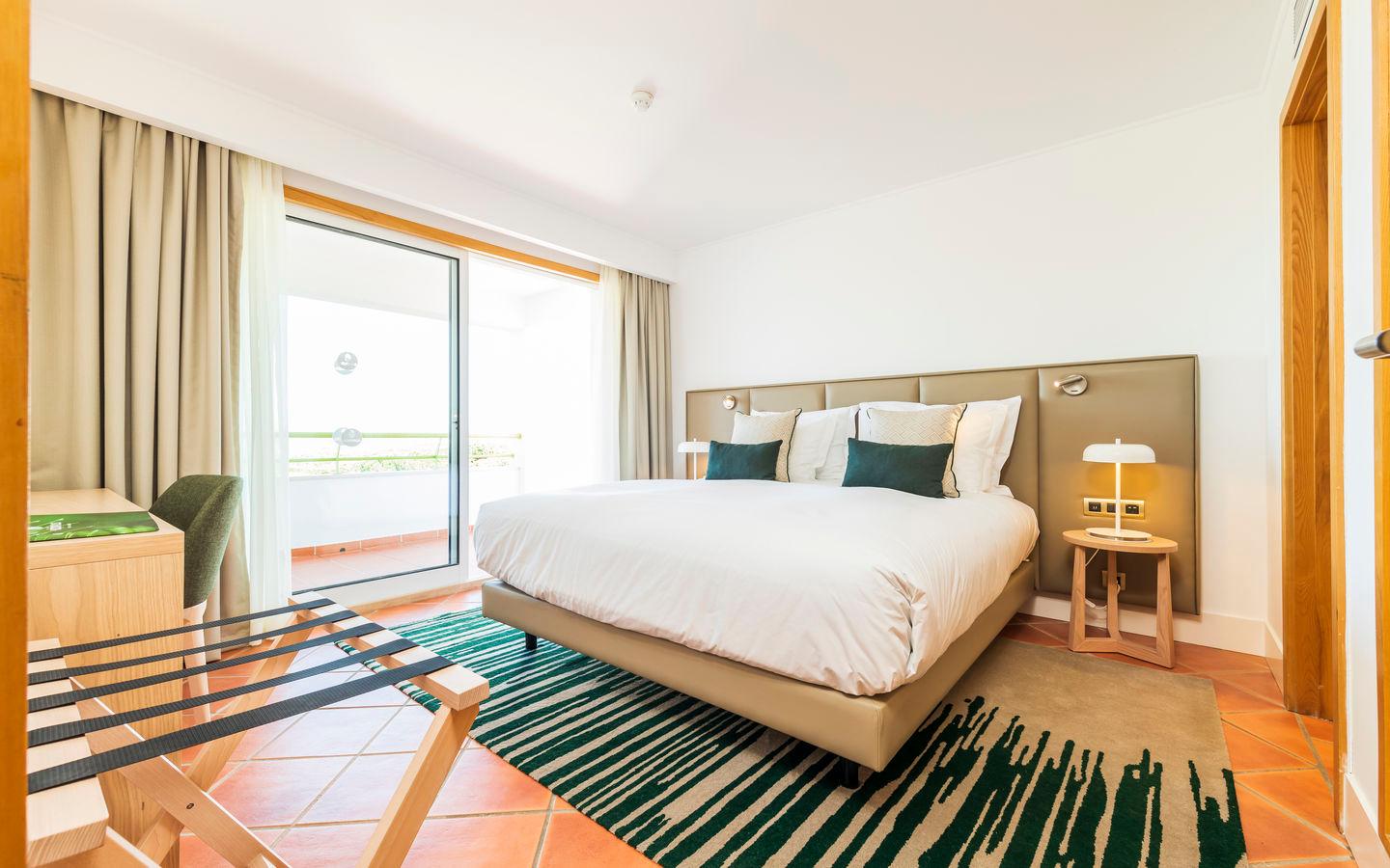 Double bed room with balcony views at The Patio Suite Hotel