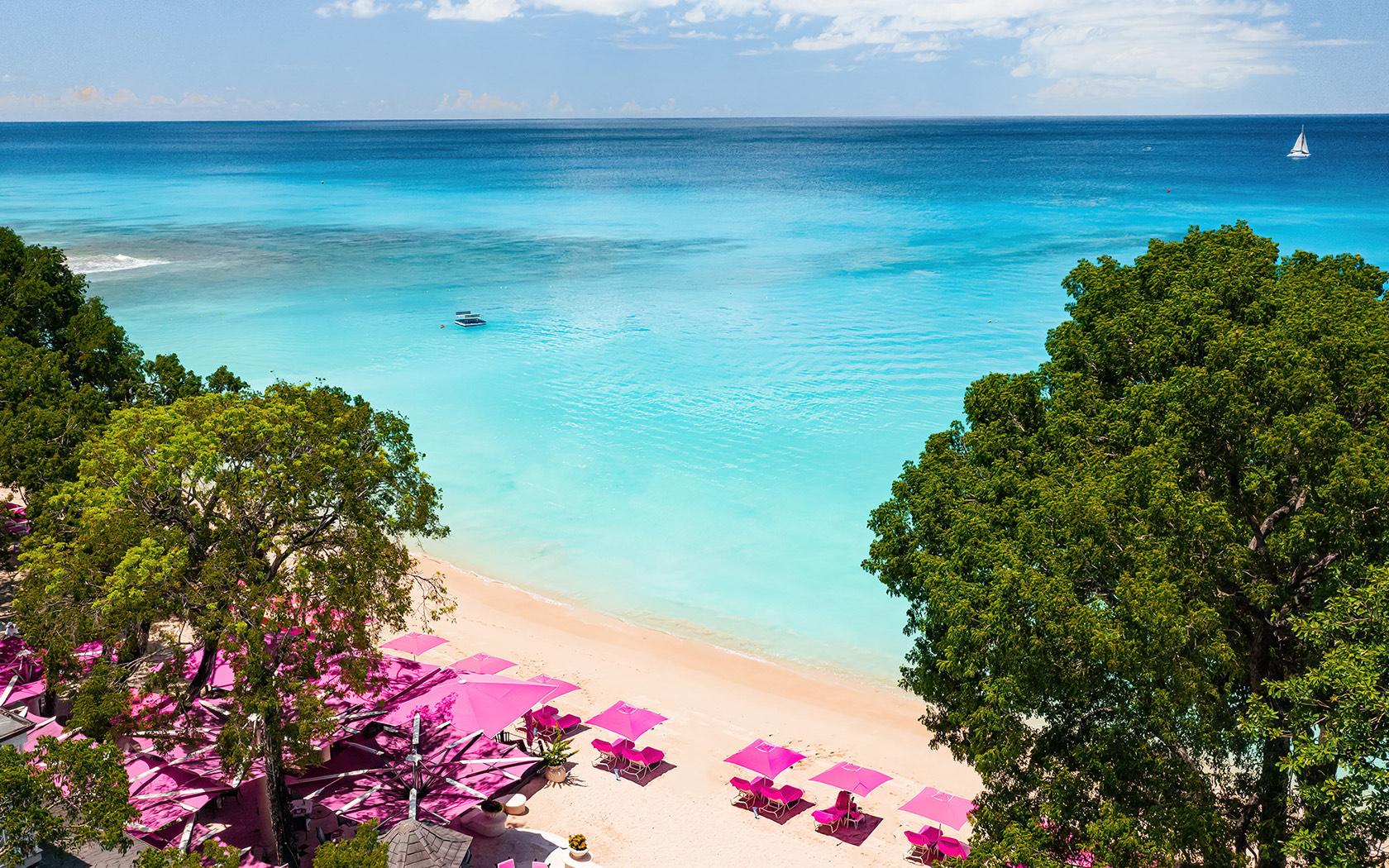 Overhead view of the Sandy Lane beach nestled with pink sunbeds