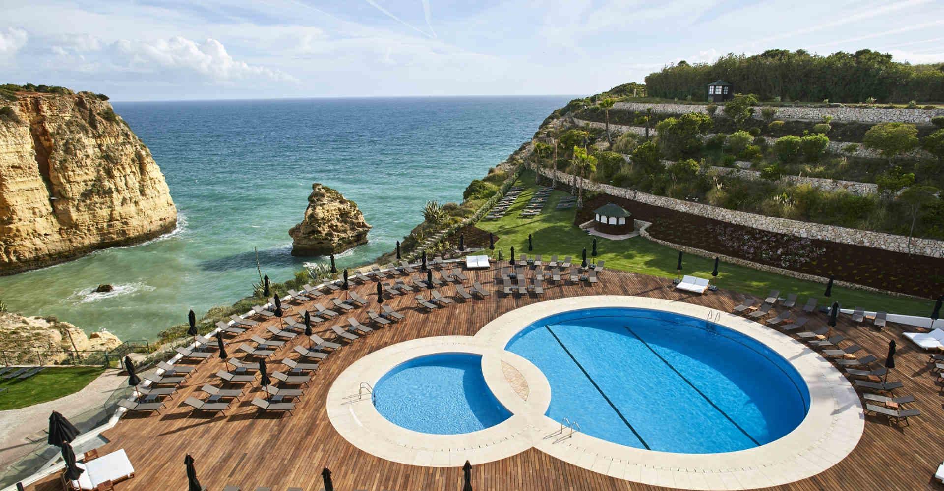 Overhead view of an outdoor swimming pool with coastal views