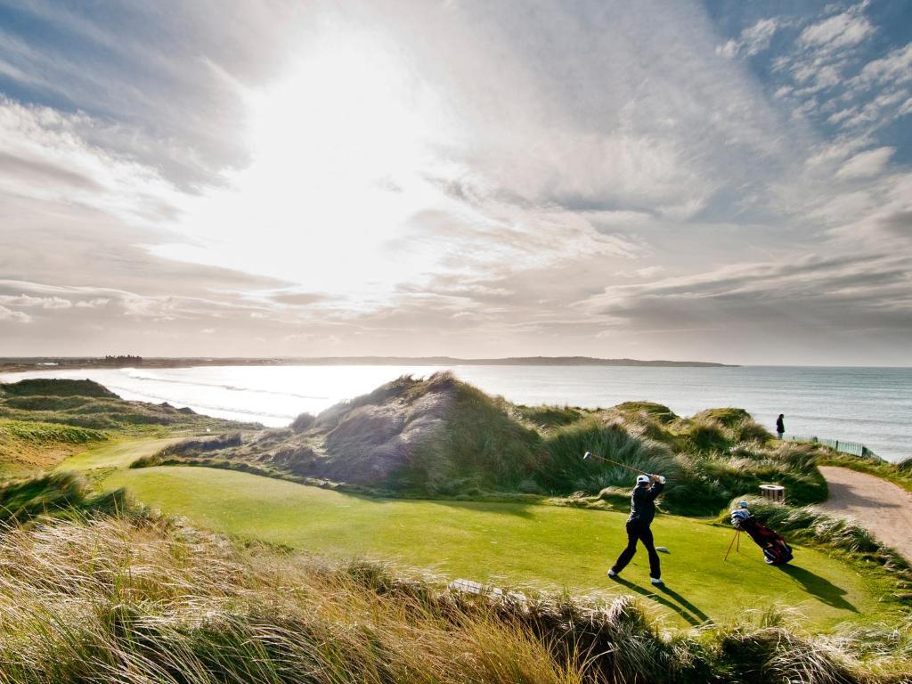 Golfer on a coastal tee box
