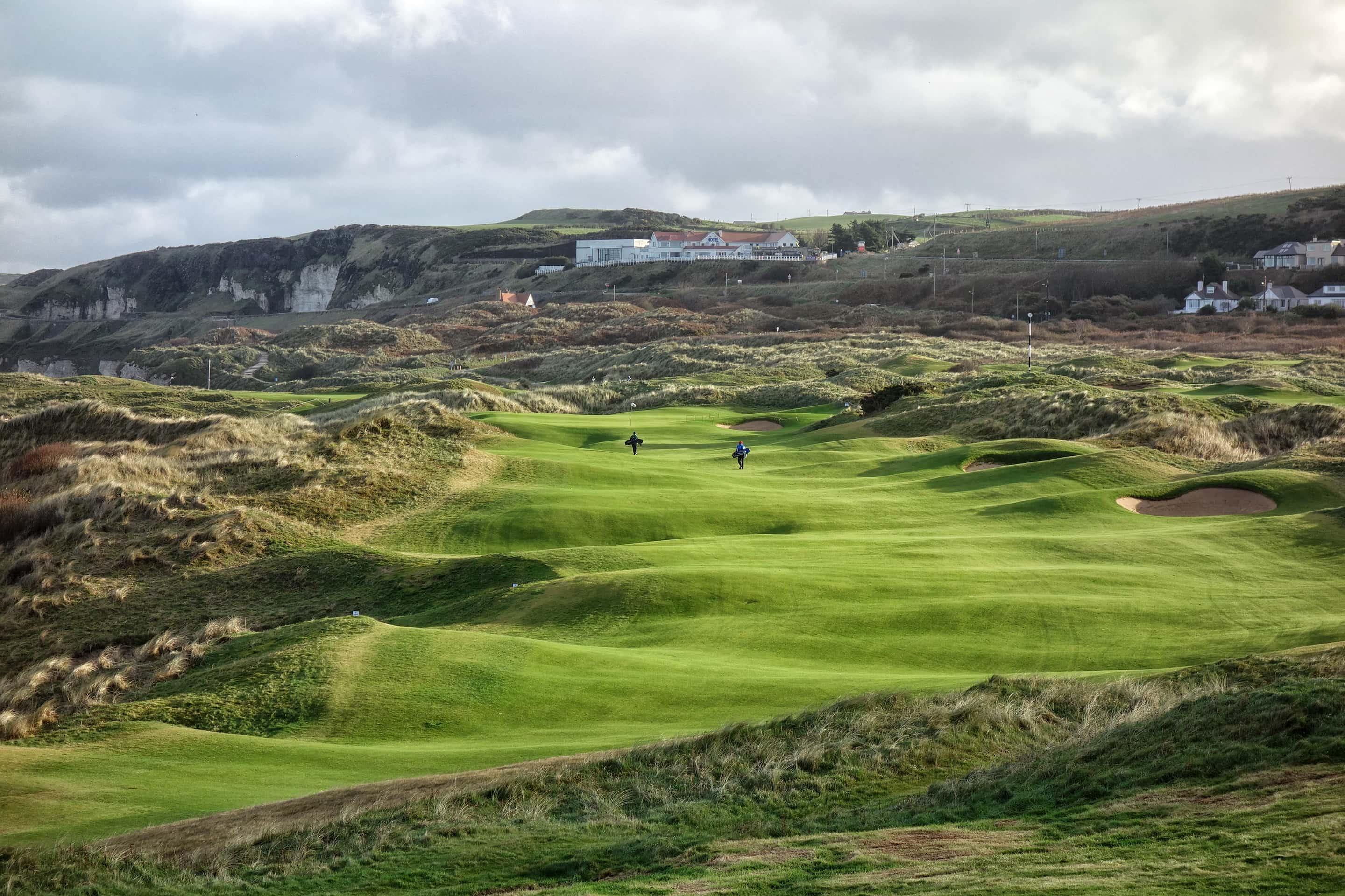 Panoramic view of a well maintained fairway under cloudy skies