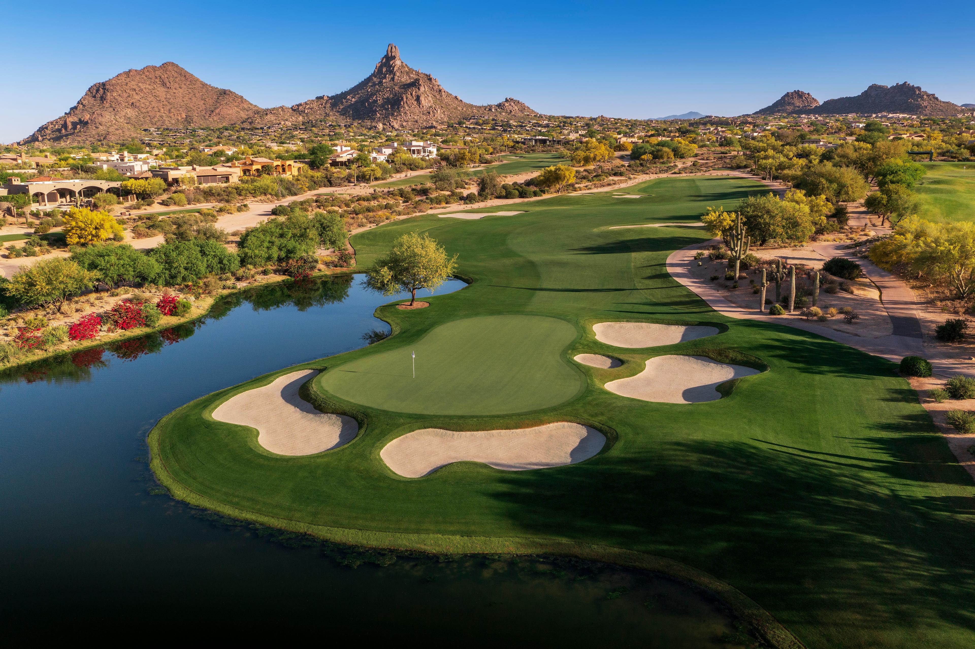 A well maintained fairway leading to a smooth green surrounded by sand bunkers