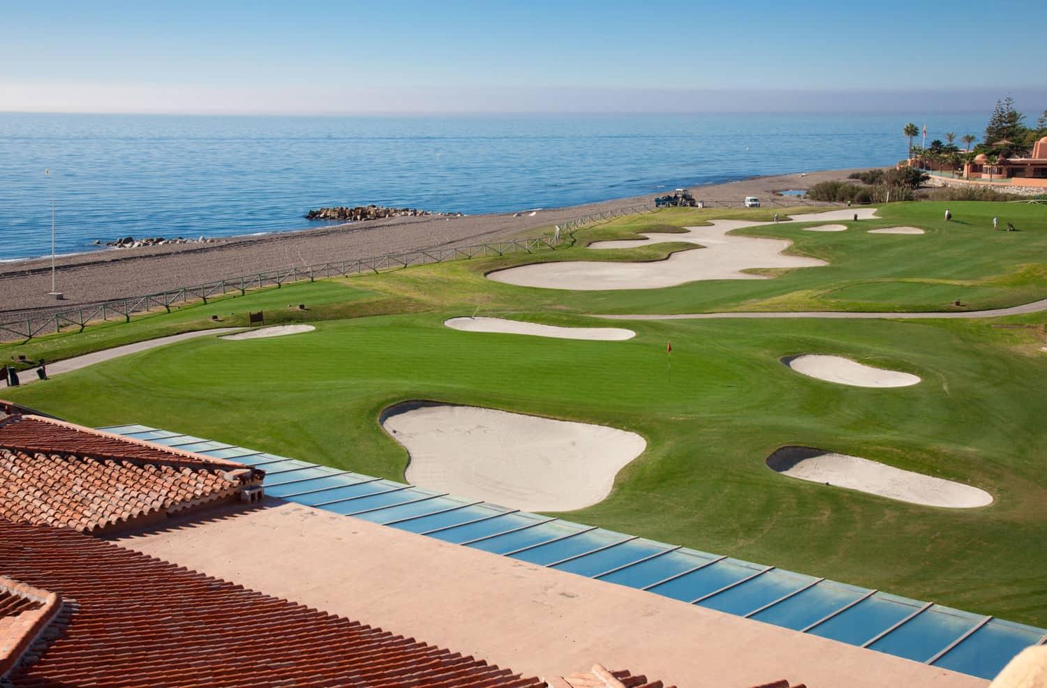 A well maintained fairway riddled with sand bunkers