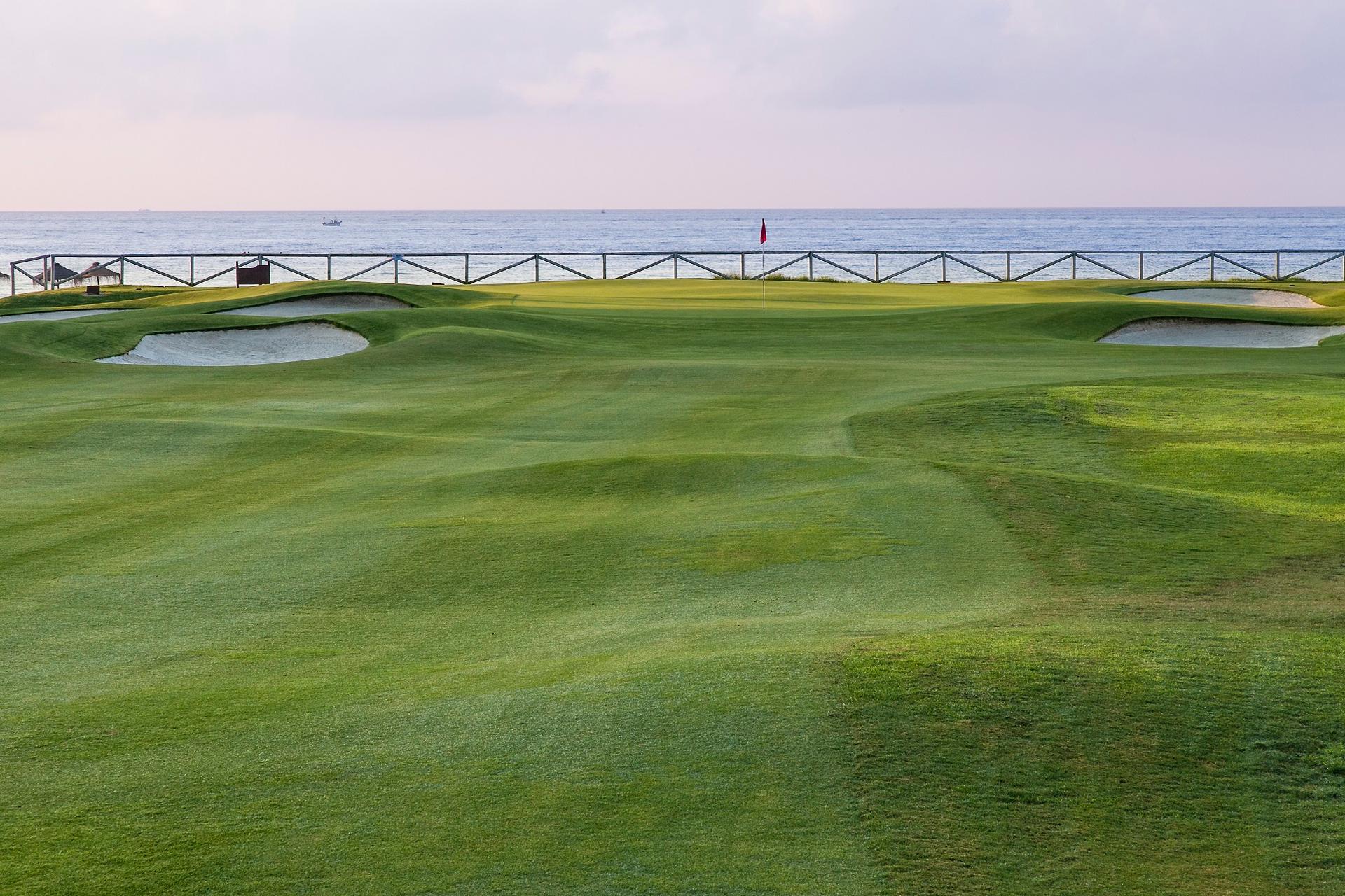 A well maintained fairway leading to a smooth coastal green