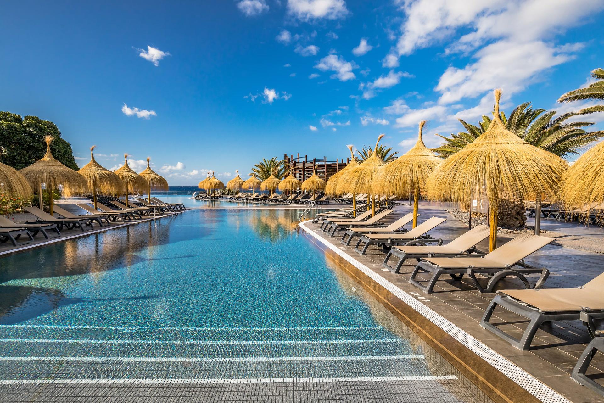 Outdoor swimming pool at the Barcelo Tenerife lined with sunbeds
