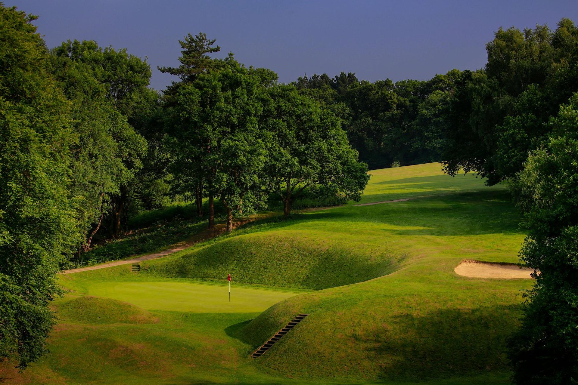Overhead view of a fairway surrounding by a raised landscape