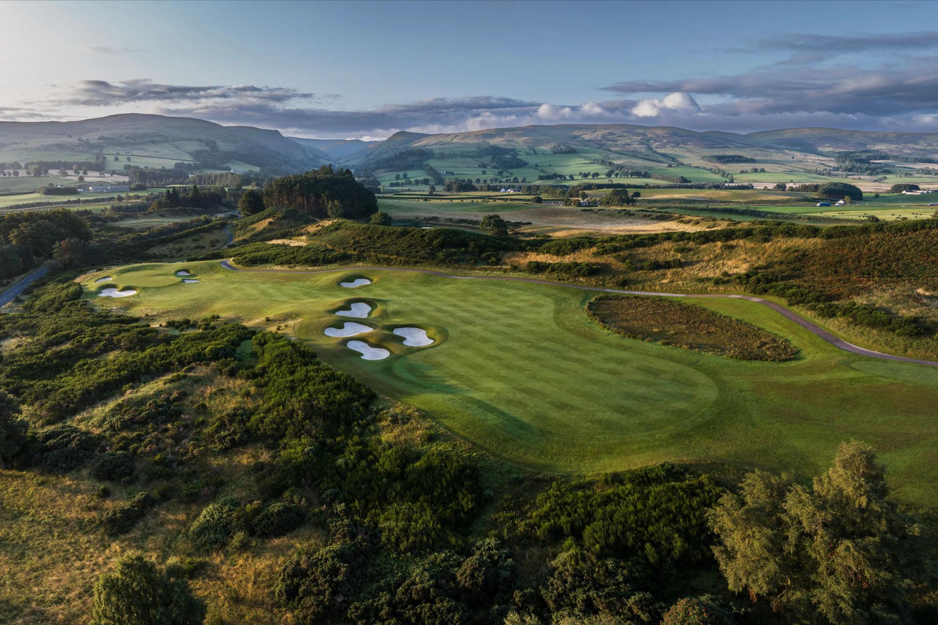 Overhead view of a smooth green next to sand bunkers