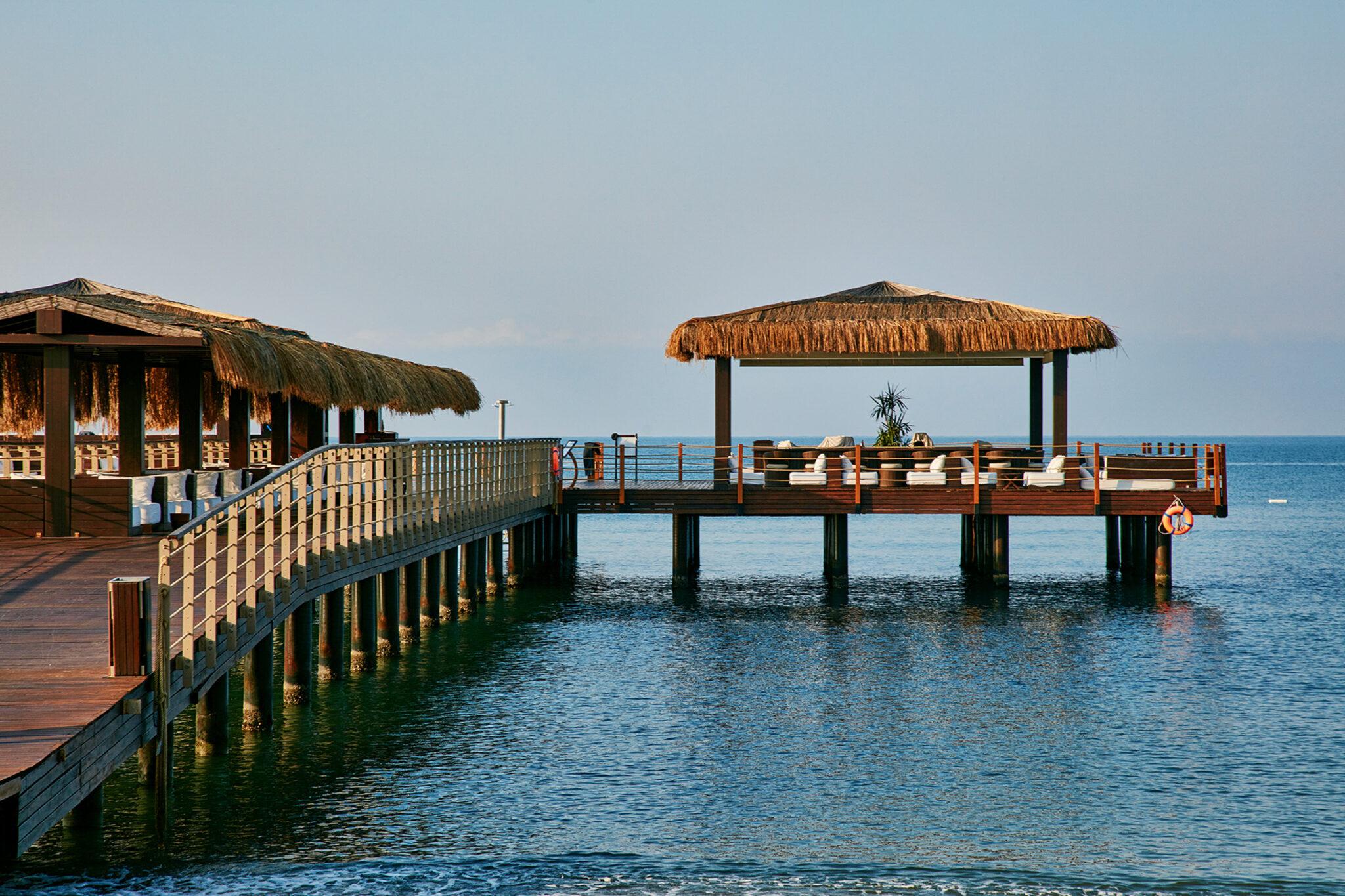 Pier on the beach with sun loungers