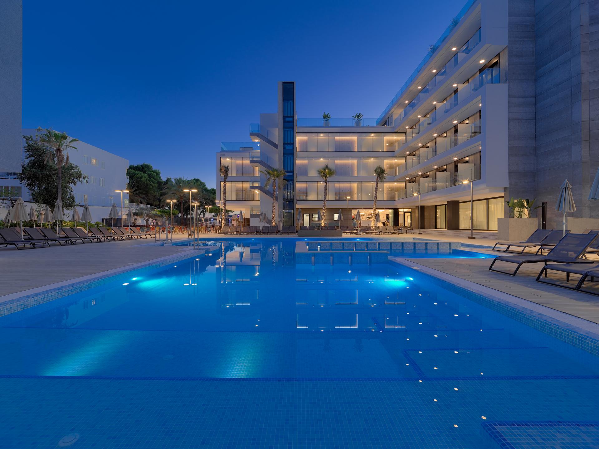 Panoramic view of the H10 Casa Del Mar reflecting off the outdoor pool at evening time