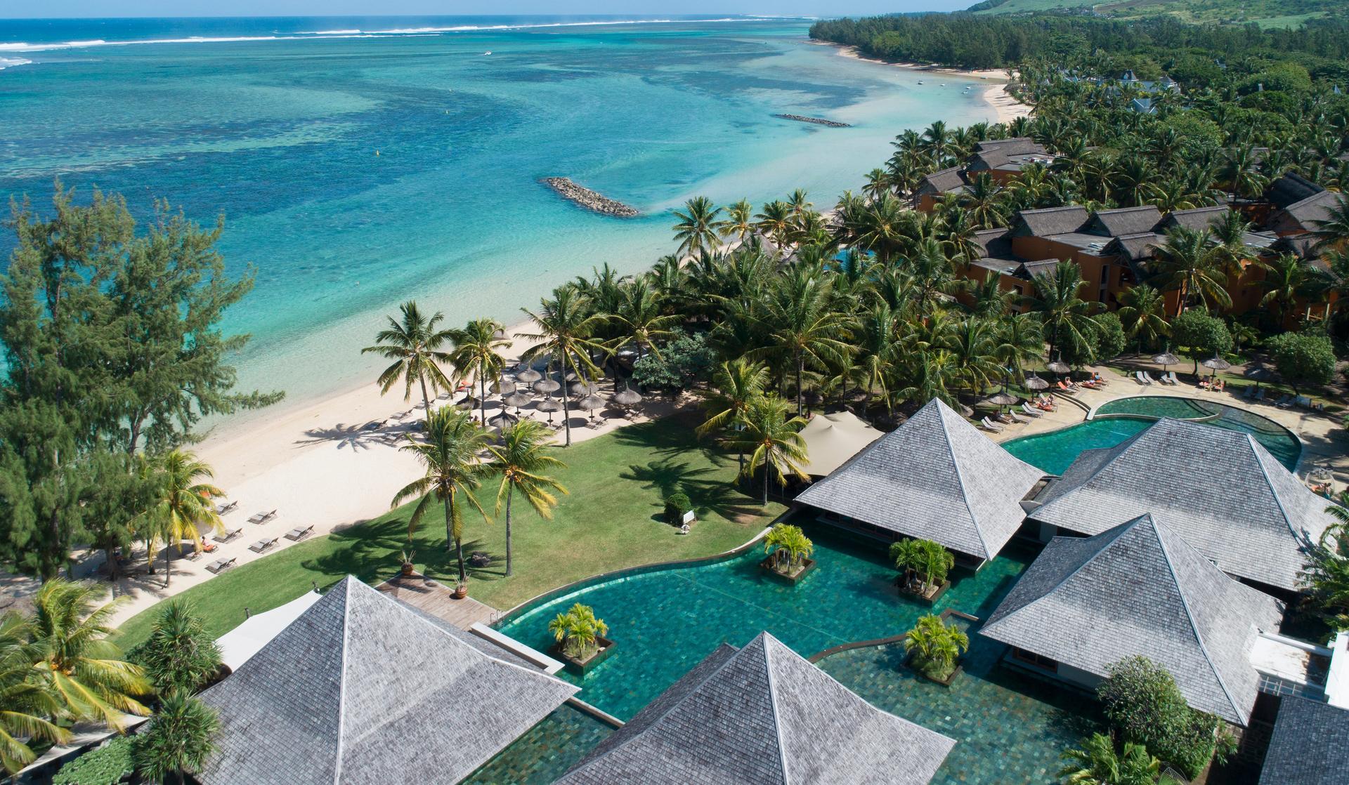 Overhead view of an outdoor swimming pool with cabanas