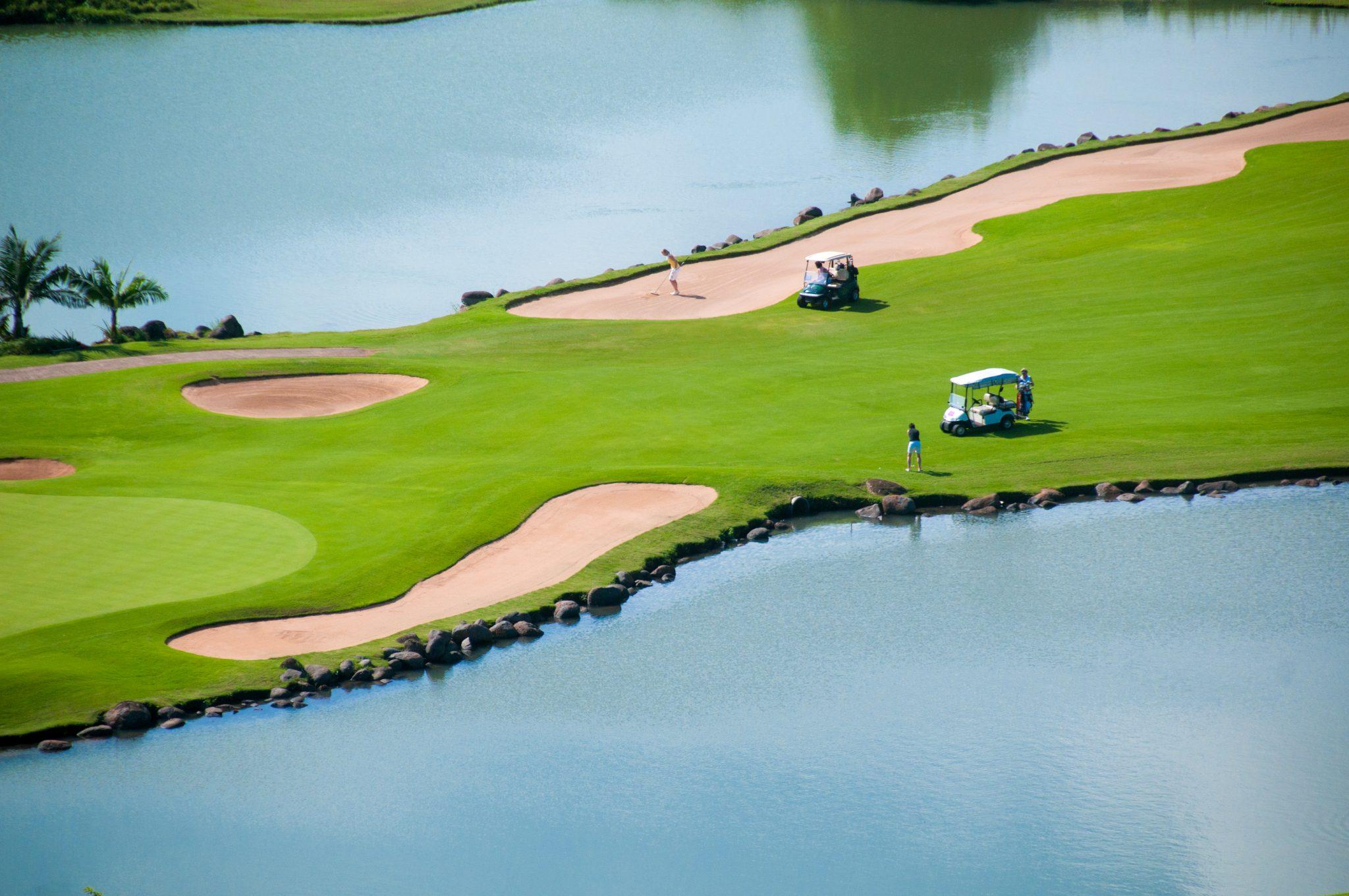 A well maintained fairway sandwiched by water hazards